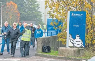  ??  ?? Worried staff leave the Michelin factory after the closure announceme­nt.