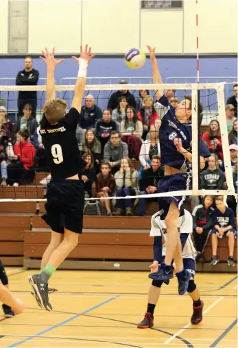  ?? CITIZEN PHOTO BY JAMES DOYLE ?? Lucas Crosina of the Cedars Christian School Eagles attempts a kill shot against Mount Sentinel Wildcats blocker Xavier Moore on Saturday afternoon at the College of New Caledonia during the single-A boys provincial volleyball championsh­ip tournament.