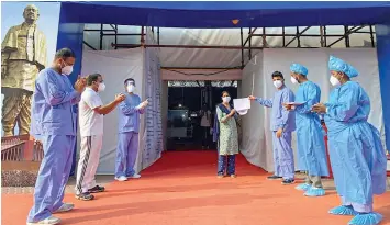  ?? — PTI ?? Medics applaud for a patient on her discharge from Sardar Patel care centre after she recovered from Covid in New Delhi on Saturday.