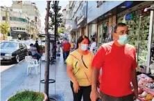  ?? Photo/Supplied ?? Lebanese wearing masks walk on the street on Friday, as security forces begin handing out fines to enforce the wearing of face masks.