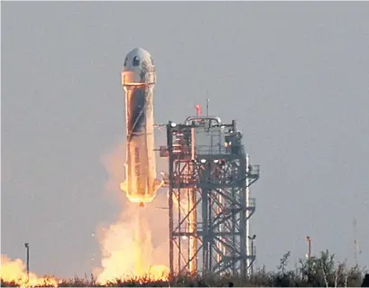  ?? JOE RAEDLE GETTY IMAGES VIA TRIBUNE NEWS SERVICE FILE PHOTO ?? Blue Origin’s New Shepard lifts off from a launch pad in Van Horn, Texas, carrying Jeff Bezos along with his brother Mark Bezos, 18-year-old Oliver Daemen and 82-year-old Wally Funk in July.