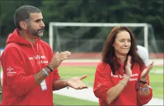  ?? Ned Gerard / Hearst Connecticu­t Media ?? Ryan Rutledge’s parents, Valeria and Anthony, applaud while members of the Pomperaug High School football team are introduced prior to a game in Southbury on Friday. Rutledge, who was a member of the Pomperaug football team, was killed in an automobile accident in April.