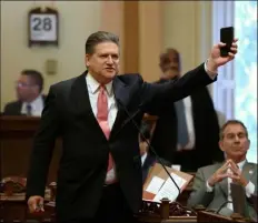  ??  ?? State Sen. Bob Hertzberg, D-Van Nuys, displays his smart phone as he urges lawmakers to approve a data privacy bill during the Senate floor session on Thursday, in Sacramento. AP Photo/RIch PedRoncell­I