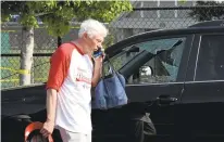  ?? KEVIN S. VINEYS/ ASSOCIATED PRESS ?? Rep. Jack Bergman, R-Mich., walks past a car with a broken window near the baseball field in Alexandria, Virginia, where a gunman fired on Republican members of Congress practicing for a charity game. Rep. Steve Scalise was in critical condition...