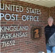  ?? (Special to The Commercial/Richard Ledbetter) ?? Johnny Cash’s cousin Wayne Cash stands at the soon-to-be renamed Kingsland Post Office.