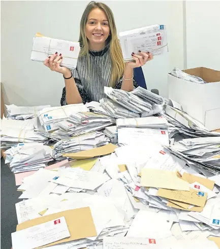  ??  ?? Annie Hunt shows off some of the letters from readers that have poured into the offices of the Daily Express