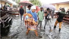  ?? | Reuters ?? VOTERS wade through flood water at a polling station during the presidenti­al election in Kinshasa, Democratic Republic of Congo, yesterday[sunday].