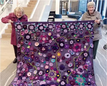  ??  ?? Lyrebird residents Elaine Charles (left) and Gwen Pierrehumb­ert show off Lyrebird’s purple road creation.