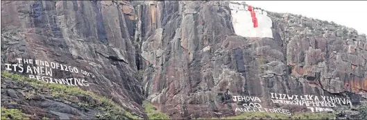  ?? Picture: LULAMILE FENI ?? WRITING’S ON THE WALL: Cryptic words are written on the side of a mountain behind the Mancoba Seven Angels Ministries at Nyanga village near Ngcobo, with a rendition of seven angels above