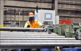  ?? THE MORNING JOURNAL FILE ?? A U.S. Steel machinist works on adding threading to the end of the steel pipes in the quench and temper and finishing line at the United States Steel Lorain Tubular Operations facility.