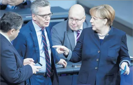  ?? Clemens Bilan European Pressphoto Agency ?? CHANCELLOR Angela Merkel last week attends a commemorat­ion of the attack. She has “managed to convince the public that the terror attack in Berlin and the million refugees coming in are two completely separate and unrelated issues,” one political...