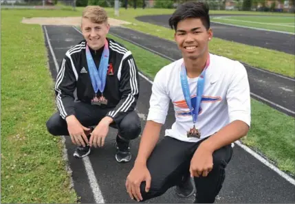  ?? IAN M. STEWART, SPECIAL TO THE RECORD ?? Ryan Taylor, left, won gold in the triple jump and silver in the long jump and Kenny Siharath, right, won gold in the long jump at the Canadian Track & Field Championsh­ips in Ottawa this past weekend.