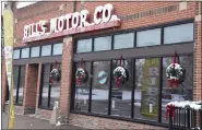  ?? SARA WAITE — JOURNAL-ADVOCATE ?? Wreaths and the Bill’s Motor Co. sign on the outside of Hot Spot Smokehouse are coated with snow Tuesday, Nov. 29, 2022.