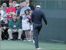  ?? Jamie Squire, Getty Images ?? Tiger Woods kicks his club after a tee shot on the 16th hole Friday.