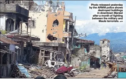  ?? AFP ?? Photo released yesterday by the ARMM police shows destroyed buildings in downtown Marawi after a month of fighting between the military and Maute terrorists.