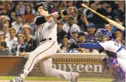  ?? DAVID BANKS/GETTY IMAGES ?? Giants’ Buster Posey loses his bat swinging at a pitch against the Chicago Cubs during a game in May.