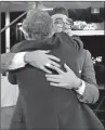  ??  ?? Eugene Levy, left, hugs his son Daniel Levy. Both won Emmys Sunday for “Schitt’s Creek.”