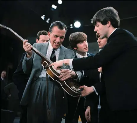  ?? THE ASSOCIATED PRESS FILE PHOTO ?? Paul McCartney, right, shows his guitar to Ed Sullivan before the Beatles’ live television appearance on The Ed Sullivan Show in 1964.