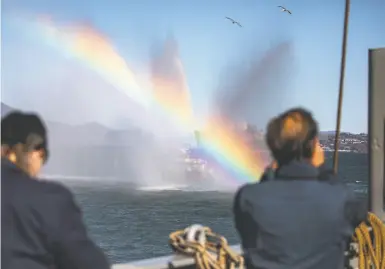  ?? Photos by Stephen Lam / The Chronicle ?? The boat from the S.F. Fire Department gives the Jeremiah O’Brien a water salute during its tow to Pier 45.