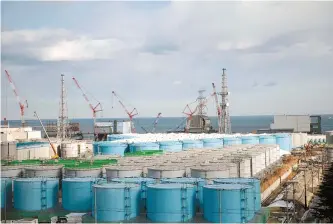  ?? AFP-Yonhap ?? This file photo taken on Jan. 31, 2018 shows, from left, unit 1 to unit 4 reactor buildings and storage tanks for contaminat­ed water at the Tokyo Electric Power Company (TEPCO) Fukushima Dai-ichi nuclear power plant in Okuma, Fukushima prefecture.