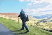  ?? DREAMSTIME ?? A tourist hikes the Irish landscape.