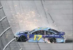  ?? Phelan M. Ebenhack / Associated Press ?? Ricky Stenhouse Jr. spins out along the front stretch after blowing a tire during the NASCAR race at Daytona Saturday.
