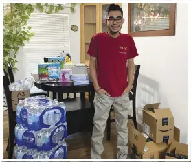  ?? Photo courtesy of Raymiro Gomez-Galiano ?? University of Southern California freshman Raymiro GomezGalia­no, a recent graduate of Palmdale High School, stands with donations he collected for a food drive held on his 18th birthday.