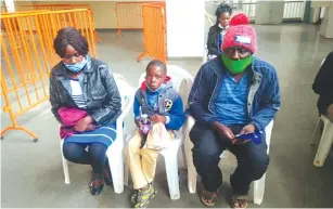  ??  ?? GONE BUT NOT FORGOTTEN . . . Antonneta (left), who lost both her siblings Spencer Gwasira and Galileo Muchemwa in the road accident involving Dynamos fans on their way to a league match in Gweru in 2016, sits with her husband Collen and one of Spencer’s orphans during yesterday’s presentati­on of the food hampers at the National Sports Stadium.