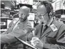  ?? RICHARD DREW/AP ?? Specialist Meric Greenbaum, left, and trader Steven Kaplan work on the floor of the New York Stock Exchange.