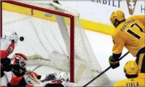  ?? MIKE STRASINGER — THE ASSOCIATED PRESS ?? Nashville’s Scott Hartnell (17) scores past Flyers goalie Brian Elliott (37) in the third period Tuesday in Nashville, Tenn.