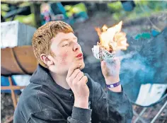  ?? ?? Burning bright: a Scout learns bushcraft on a camping trip in Ceredigion, Wales