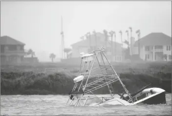  ?? ASSOCIATED PRESS ?? A BOAT SINKS IN THE PACKERY Channel during Hurricane Hanna on Saturday in North Padre Island, Texas. The Category 1 storm continued to strengthen before reaching Padre Island at 5 p.m. Saturday.