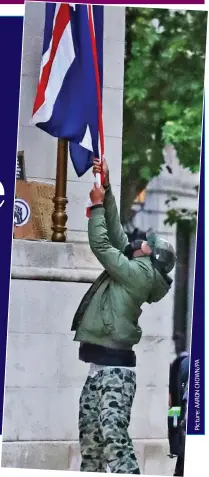  ??  ?? Attacking the flag: A protester at the Cenotaph