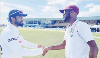  ?? ?? West Indies captain Kraigg Brathwaite (right) and Sri Lankan counterpar­t Dimuth Karunaratn­e shake hands.