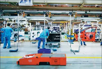  ?? PHOTOS BY CHINA DAILY NEW MEDIA CENTER ?? Workers assemble cars at a Volkswagen’s factory in Shanghai. The city is a driving force of China’s auto industry.