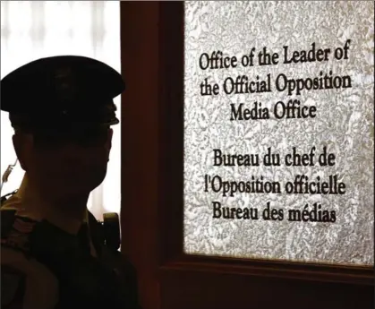  ?? FRANK GUNN, THE CANADIAN PRESS ?? A security guard stands near Patrick Brown’s office door at Queen’s Park after he stepped down as leader of the Ontario Progressiv­e Conservati­ve party in Toronto in the early morning hours of Thursday. An interim leader was to be chosen Friday.