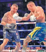  ??  ?? Josh Warrington catches Carl Frampton