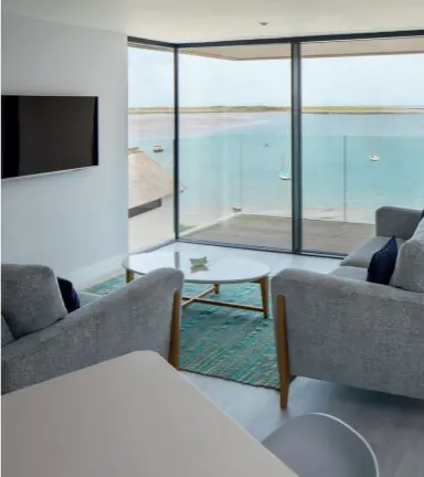  ??  ?? Right: the living room is on the first floor of the property so occupants can enjoy the dramatic sea views
