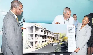  ??  ?? In this March 2013 photo (from left) Jamaican Teas director John Jackson and project manager Randy Mair show off the company’s first real estate project to Claudine West of BDO. Jamaican Teas now plans to spin off its property operation into a...