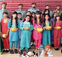  ?? Supplied photos ?? All dressed up, children of RAK prisons’ staff members and inmates hold up their bowl of Hag Al Laila sweets. —