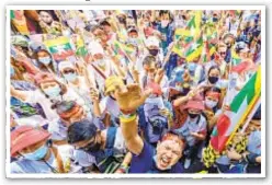  ??  ?? Myanmar migrants in Bangkok protest Sunday against the military coup in their home country.