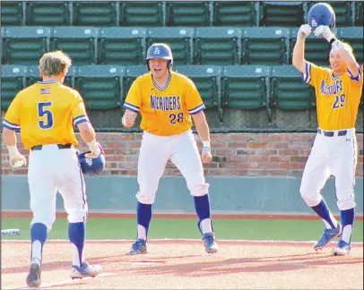  ?? Submitted photo ?? MULERIDERS: Lake Hamilton alum Zach Muldoon (28) waits at home plate with fellow Muleriders Cole Boyd (29) and James Trevanion to greet Austin Baker (5) at home plate after Baker hit a grand slam in the seventh inning on May 7 against Henderson State...