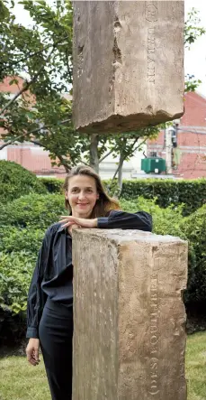  ??  ?? French artist Zoe Vayssieres poses next to her sculpture work “Doors to Memory” at Jing’an Sculpture Park. — Francois Trezin