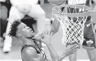  ?? LYNNE SLADKY/ AP ?? Heat forward Jimmy Butler goes to the basket against the Bulls on Monday in Miami.