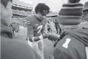  ?? GREGORY SHAMUS Getty Images ?? Ohio State quarterbac­k C.J. Stroud signs autographs for young fans after tossing a school record six first-half touchdown passes Saturday against Michigan State.