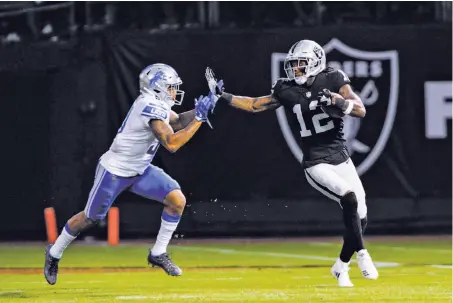  ?? Icon Sportswire via Getty Images ?? Martavis Bryant, stiff-arming a Detroit player, sometimes comes to play and sometimes doesn’t, head coach Jon Gruden said.