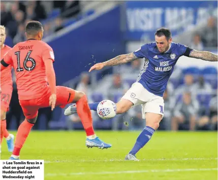  ??  ?? > Lee Tomlin fires in a shot on goal against Huddersfie­ld on Wednesday night