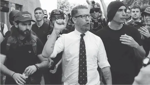  ?? MARCIO JOSE SANCHEZ / THE ASSOCIATED PRESS FILES ?? Gavin McInnes, centre, founder of the far-right group Proud Boys, with supporters in 2017 after speaking at a rally in Berkeley, Calif. McInnes and his Proud Boys group have been banned from Facebook and Instagram, and now the FBI has categorize­d them as extremist.