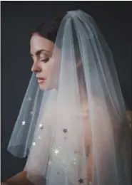  ?? WHAT KATY DID NEXT — ETSY VIA AP ?? This fingertip-length tulle veil with starry trim is made by Katy Howieson in her Sedgefield, England studio.