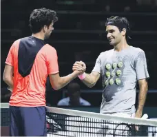  ?? AFP ?? Roger Federer shakes hands with Netherland­s’ Robin Haase after a training session in Rotterdam on Monday